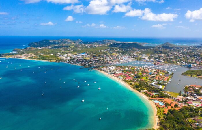 rodney bay Rodney Bay, st Lucia. Aerial view of a tropical coastline with turquoise water, sandy beaches, and a town along the shore with boats in a marina and green hills in the distance.